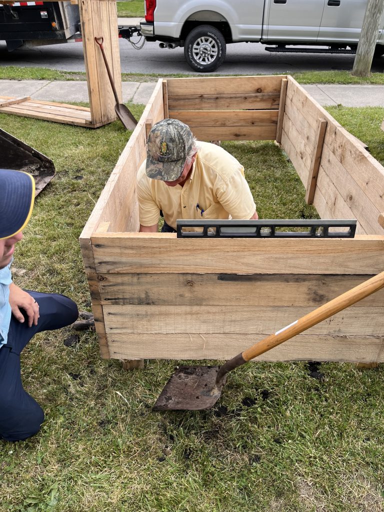 Mike Werling (Allen County SWCD) at Bloomingdale Gardens in Fort Wayne, Indiana, installing a raised garden bed.